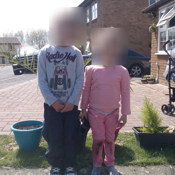 It looks a bit dramatic, but had to blur their faces for obvious reasons.  THis is them with their sunflower pots....the little girl is in front of hers